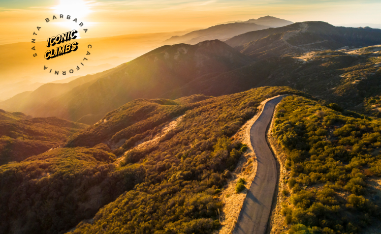 Sunset over a mountainous landscape with a winding road, featuring the Santa Barbara Iconic Climb logo.